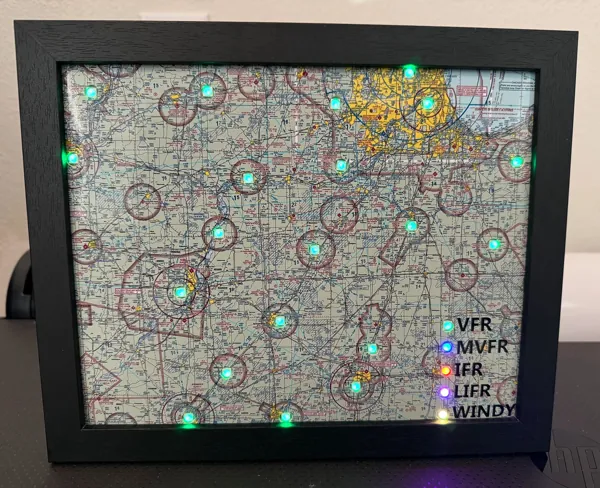 A framed sectional map on a desk with green airport lights and a lit legend