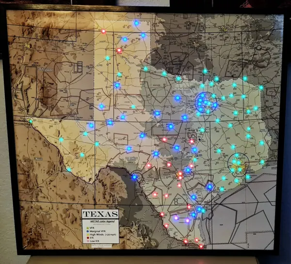 A map cut to the shape of Texas, lit in green and blue