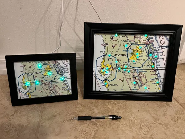 A small and a large framed map, both lit