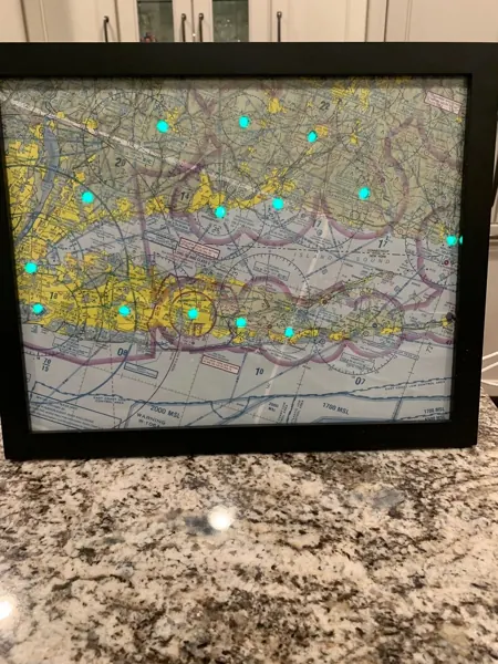 A tall framed sectional map with green lights, on a counter