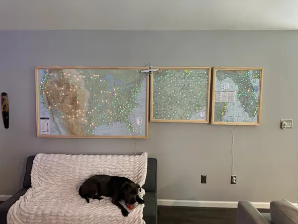 Three large framed maps hung together on a living room wall