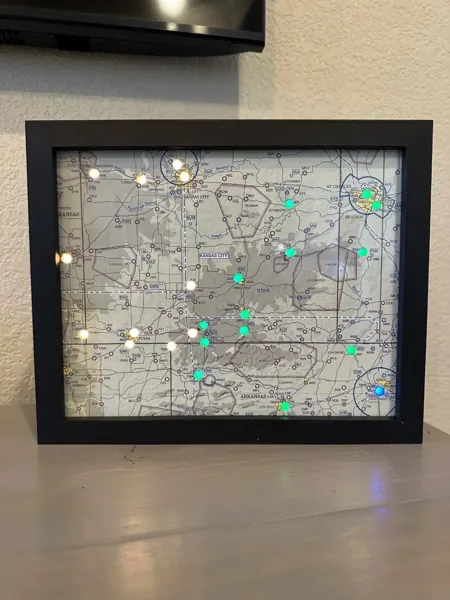 A framed map with lights, standing on a table