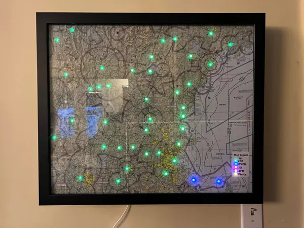 A framed sectional on a wall with green and blue airport lights